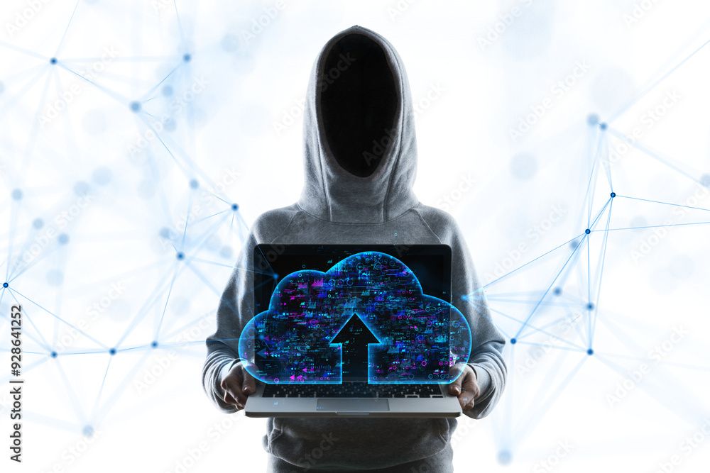 Aufkleber faceless person in a hoodie holding a laptop with a holographic cloud upload symbol, standing agains