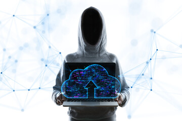 Faceless person in a hoodie holding a laptop with a holographic cloud upload symbol, standing...