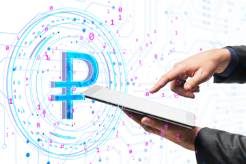 Hands interacting with a tablet, displaying a digital ruble symbol surrounded by binary code. Modern digital currency concept on white background