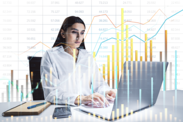 Businesswoman working on a laptop with colorful financial charts overlayed, on a white background. Concept of data analysis and finance