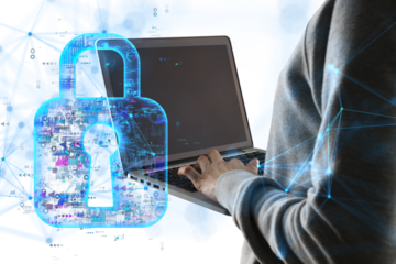 A person typing on a laptop with a holographic lock overlay on a white background. Concept of cybersecurity and data protection