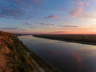Fototapeta premium River at Sunset with Trees and Fields on the Shore, Perspective View