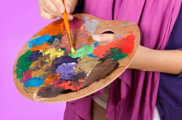 Artist Painting with Palette and Brush in Studio