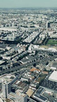 Aerial shot of residential district and industrial facilities in Gennevilliers to the north of Paris, France, vertical video