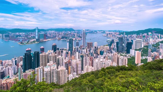 Hong Kong Timelapse. Stunning view from Peakwith Victoria harbour in between Hong Kong Island and Kowloon Peninsula with commercial and residential buildings. No recognized logos. Wide zoom in shot. 