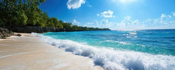 Obraz premium Breathtaking tropical beach showcasing turquoise water, soft sand, and lush greenery under a bright blue sky.