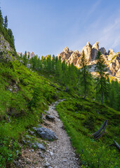 Hiking trail going up the mountains. Clear sunny summer day. Dolomites. Italy. Hiking, tourism,...