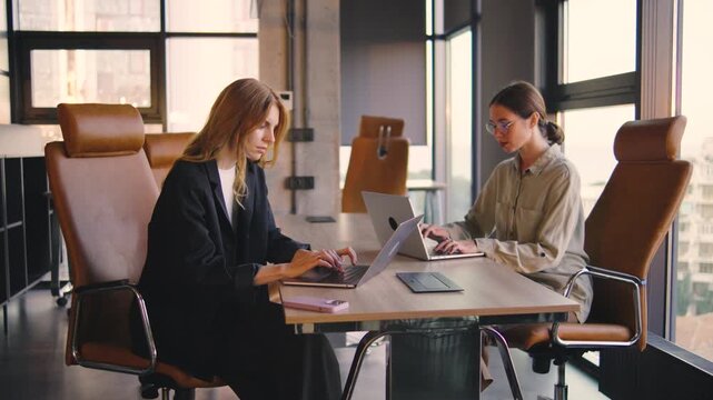Professional women effectively collaborating and innovating within a modern office environment that fosters teamwork, communication, and creativity to achieve their career goals and success