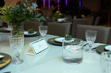 table set for a wedding reception, interior of a restaurant, room interior, table setting at restaurant, wedding table setting, table set for a dinner