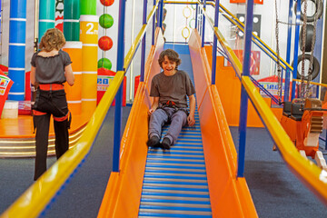 happy boy on a sports hill in a training hall. Active family recreation