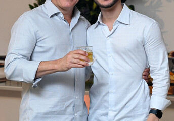 man with glass of whisky, two men, side by side, person with glass of whisky