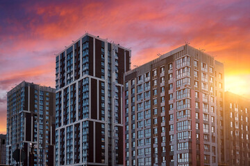 Fototapeta premium Construction of a beautiful modern residential complex against the sky.