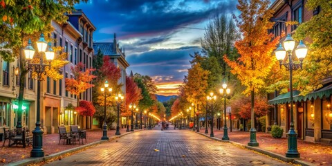 Obraz premium Autumnal Street Scene with Illuminated Lamp Posts, Brick Road, and Vibrant Foliage, fall foliage, street lights, brick road, autumn cityscape