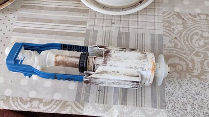 Old toilet flush system on table