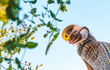 Woman in the park with flowers summer. Selective focus.