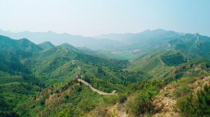 Create a photo of the Great Wall of China, highlighting its extensive length, historical significance, and breathtaking mountainous surroundings.