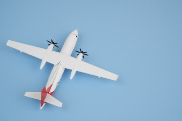 Airplane model on blue background. Copy space for text.