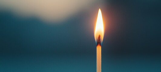 A serene candle flame glowing softly in a tranquil setting, creating a peaceful and warm atmosphere.