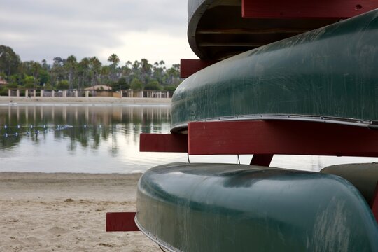 stack of canoes along the shoreline