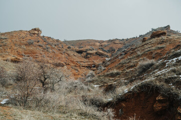 View of the hills of bentonite or red clay in the countryside outside the city