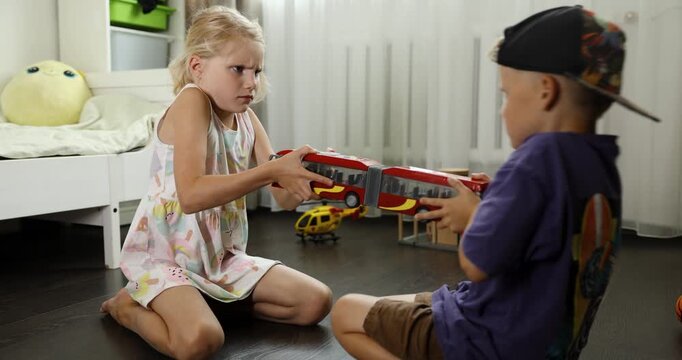 kids are fighting over a toy. conflict between sister and brother. sibling relationships