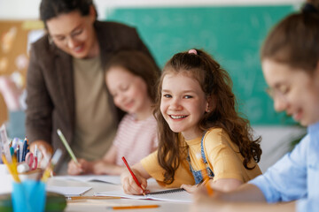 Happy kids and teacher at school