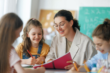 Happy kids and teacher at school