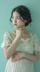 Fototapeta premium A middleaged pregnant Asian woman standing with on 009 woman, beauty, hair, fashion, model, dress, face, lady, glamour, studio, long, person, smile, blond, people, hairstyle, eyes, brunette, lips, bl