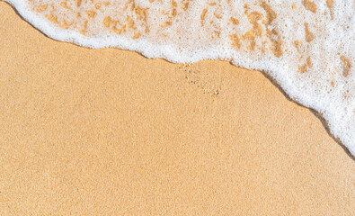 Sand beach with white foamy on daylight top view seaside in summer season well space for text presentation 