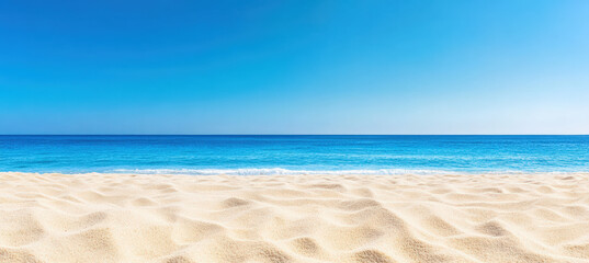 Obraz premium Tropical beach with white sand, clear turquoise water, and a bright blue sky. The scene is tranquil and represents a perfect summer day.