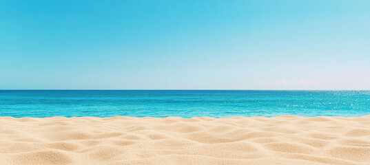 Fototapeta premium Panoramic view of a sandy beach with gentle waves and a clear blue sky, showcasing the serene beauty of a tropical coastline.
