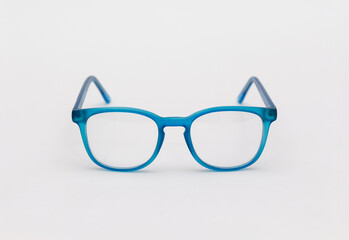 Fototapeta premium Prescription glasses with blue frames on a white background