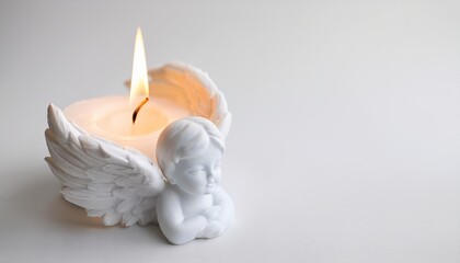 Angel shaped white candle on a white backgrounf