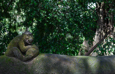 A Serene Monkey Sculpture and Lush Greenery Surroundings