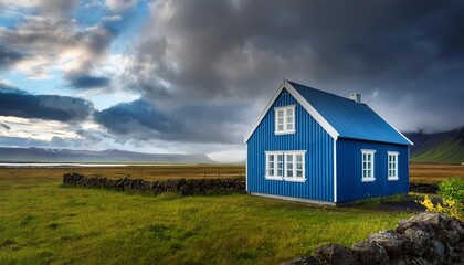 Obraz premium Blue House Under Cloudy Sky in Iceland
