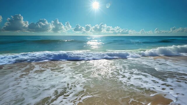 Sun shining over ocean waves crashing on sandy beach