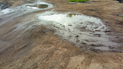 The road was washed away by the rain. Impassability of roads. Puddles and mud on the highway. The rainy season. Potholes. 