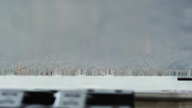 Macro photography of the procedure of stretching a cellular metallic mesh to achieve its final appearance. Close up. Slow motion