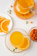 Sea buckthorn tea drink with oranges and mint. Autumn comfort hot drink. Herbal vitamin tea. 
