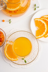 Sea buckthorn tea drink with oranges and mint. Autumn comfort hot drink. Herbal vitamin tea. 