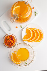 Sea buckthorn tea drink with oranges and mint. Autumn comfort hot drink. Herbal vitamin tea. 