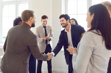 Office business group, hr managers welcoming new employee to team, giving handshake candidate at job interview, meeting, diverse team thanking professional, leader shaking hand satisfied negotiations