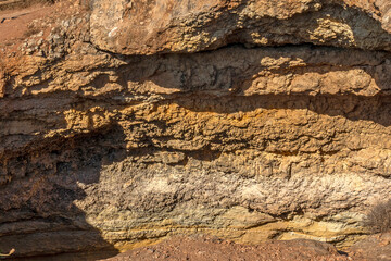 Layers of sediment in rocks seen on thecoastline between Marinha Beach and Vale Centeanes Beach,...