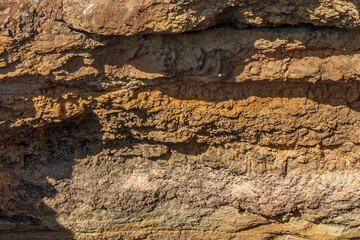Layers of sediment in rocks seen on thecoastline between Marinha Beach and Vale Centeanes Beach, Algarve, Portugal, Europe.