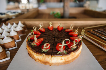 Chocolate cake with strawberries. Cake with chocolate decorated with various berries strawberries on a table.