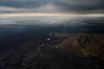 Grindavik Iceland and the steaming lava from the most recent volcanic eruption