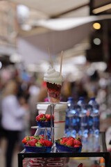 Fresh strawberries and dessert at an outdoor market