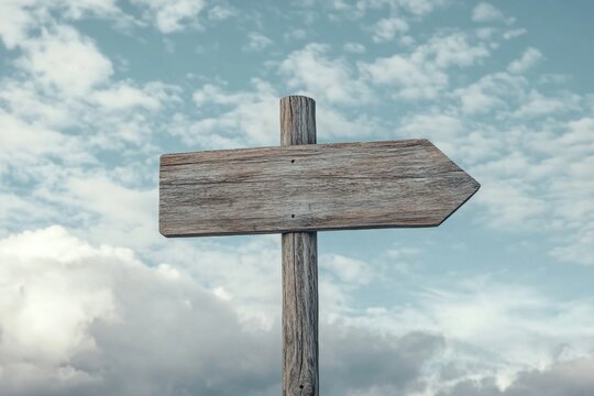 Wooden Direction Sign Under Cloudy Skies: A Symbol of Decisions and Choices in Life's Journey. Embracing the Path of Growth and Discovery.