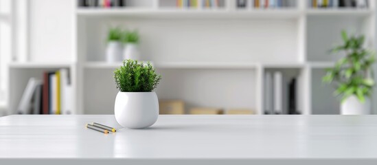 Fototapeta premium white table with office supplies, blurred background of an open space or home interior with bookshelves