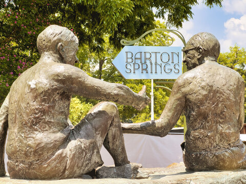 AUSTIN, TEXAS, USA - AUGUST 9, 2024: Philosopher's Rock sculpture in Zilker Park near Barton Springs Pool, Austin, Texas. Designed by Glenna Goodacre, the sculpture depicts three notable Austinites.